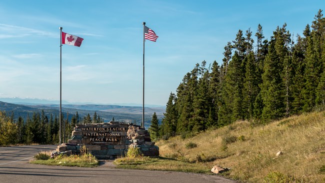Park sign with Canadian and US flag with mountains in background. Photo by Martin Kraft, CC BY-SA 3.0, https://commons.wikimedia.org/w/index.php?curid=38015817 Park sign with Canadian and US flag with mountains in background. Photo by Martin Kraft, CC BY-SA 3.0, https://commons.wikimedia.org/w/index.php?curid=38015817