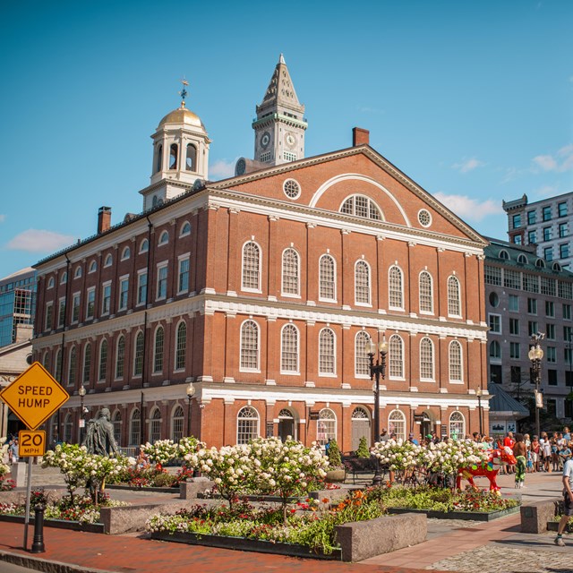 a four-story brick building with a cupola