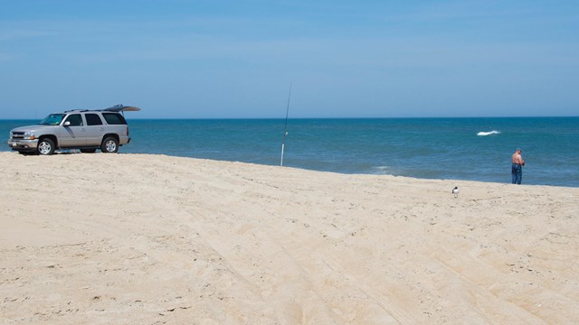 Fisherman on beach with ORV
