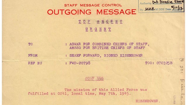 A paper document with text containing Eisenhower's message on VE Day